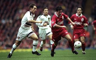 Liverpool's Robbie Fowler shields the ball from Manchester United's Gary Neville during a 1996 match at Anfield