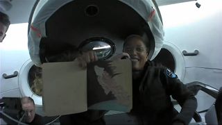 Sian Proctor shows off art she made while orbiting Earth during the Inspiration4 mission.