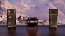 JBL Makalu speakers on either side of a hi-fi system with a backdrop showing Himalayan mountain peaks.
