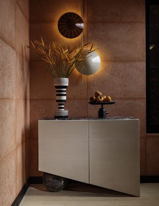 A corner with a bar cabinet and designer wall lights
