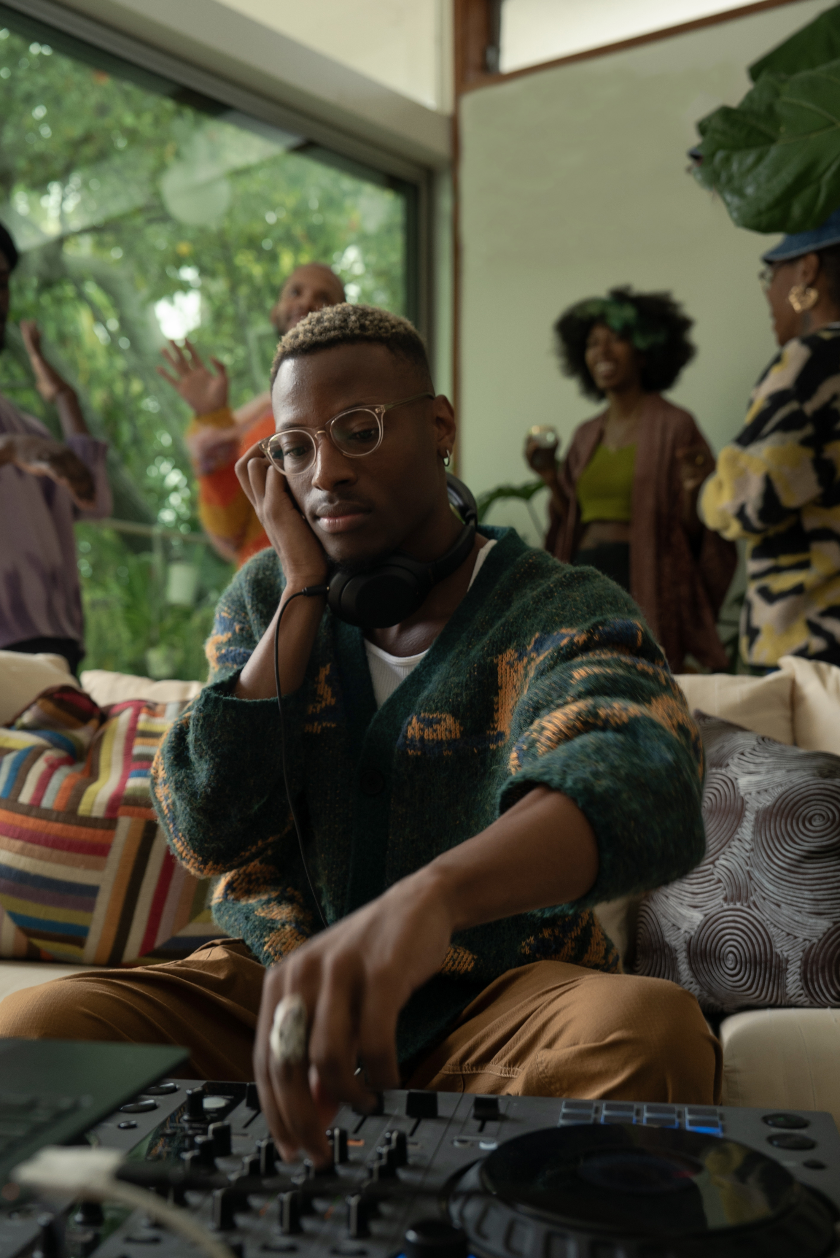 man in a jumper on a softa at a party