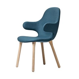 &Tradition Catch chair with blue upholstery and bare wood legs.
