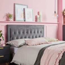 grey velvet headboard and pillows in pink bedroom