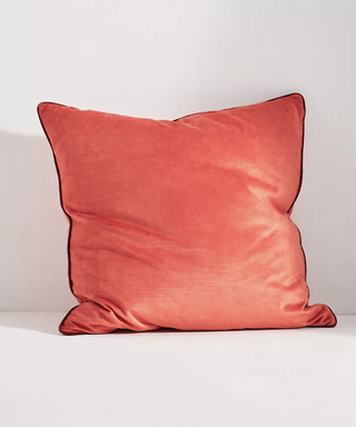 Light red velvet throw pillow with contrast piping from Anthropologie.