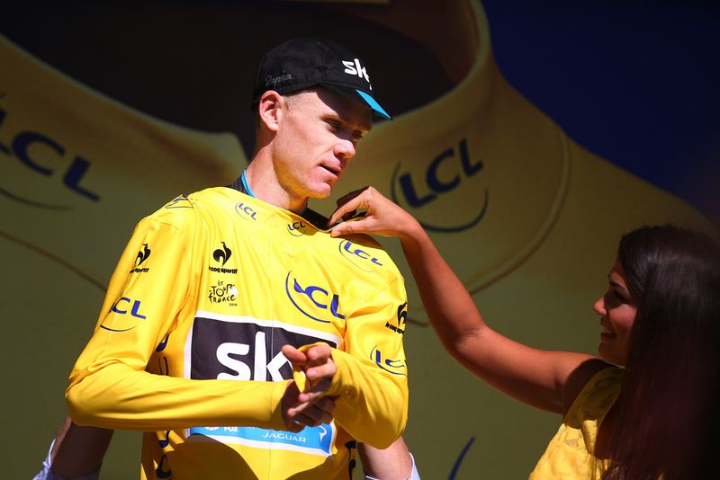 Chris Froome gets a helping hand to collect his 16th yellow jersey