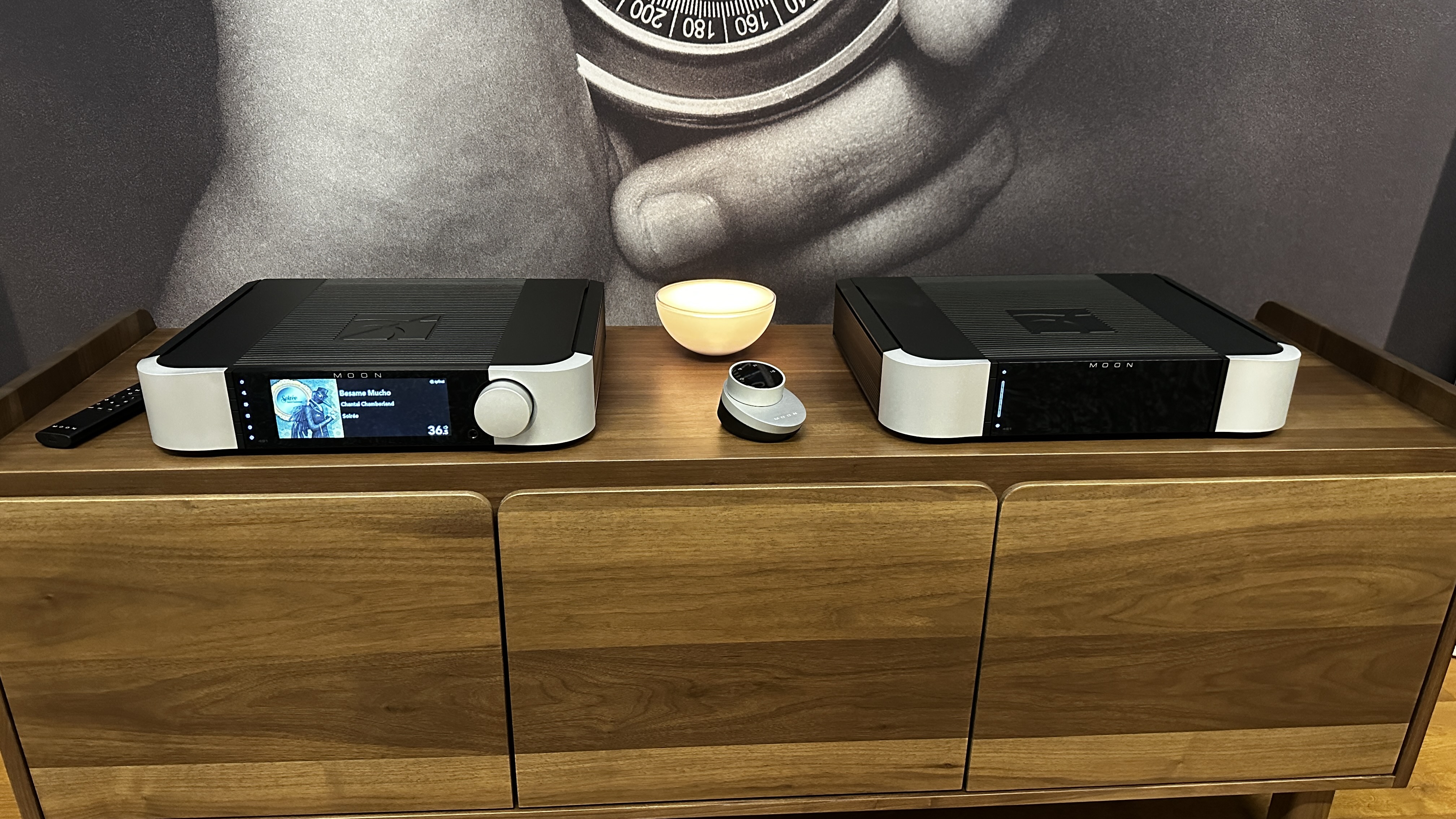 Moon 491 streaming preamp with 461 power amp on wooden cabinet