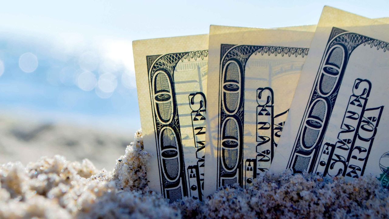 Three, hundred bills buried in the sand