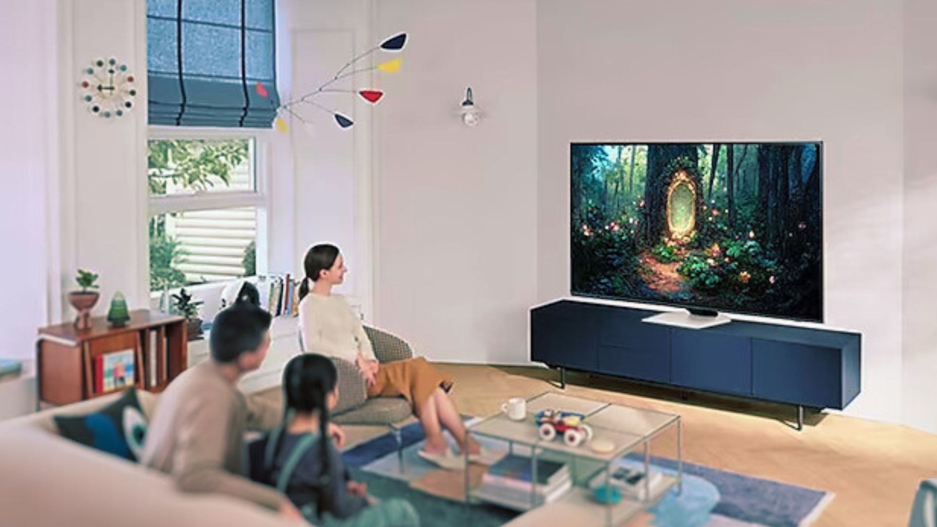 Samsung QN85C-Heldenbild einer Familie, die sich im Wohnzimmer vor dem Fernseher versammelt hat