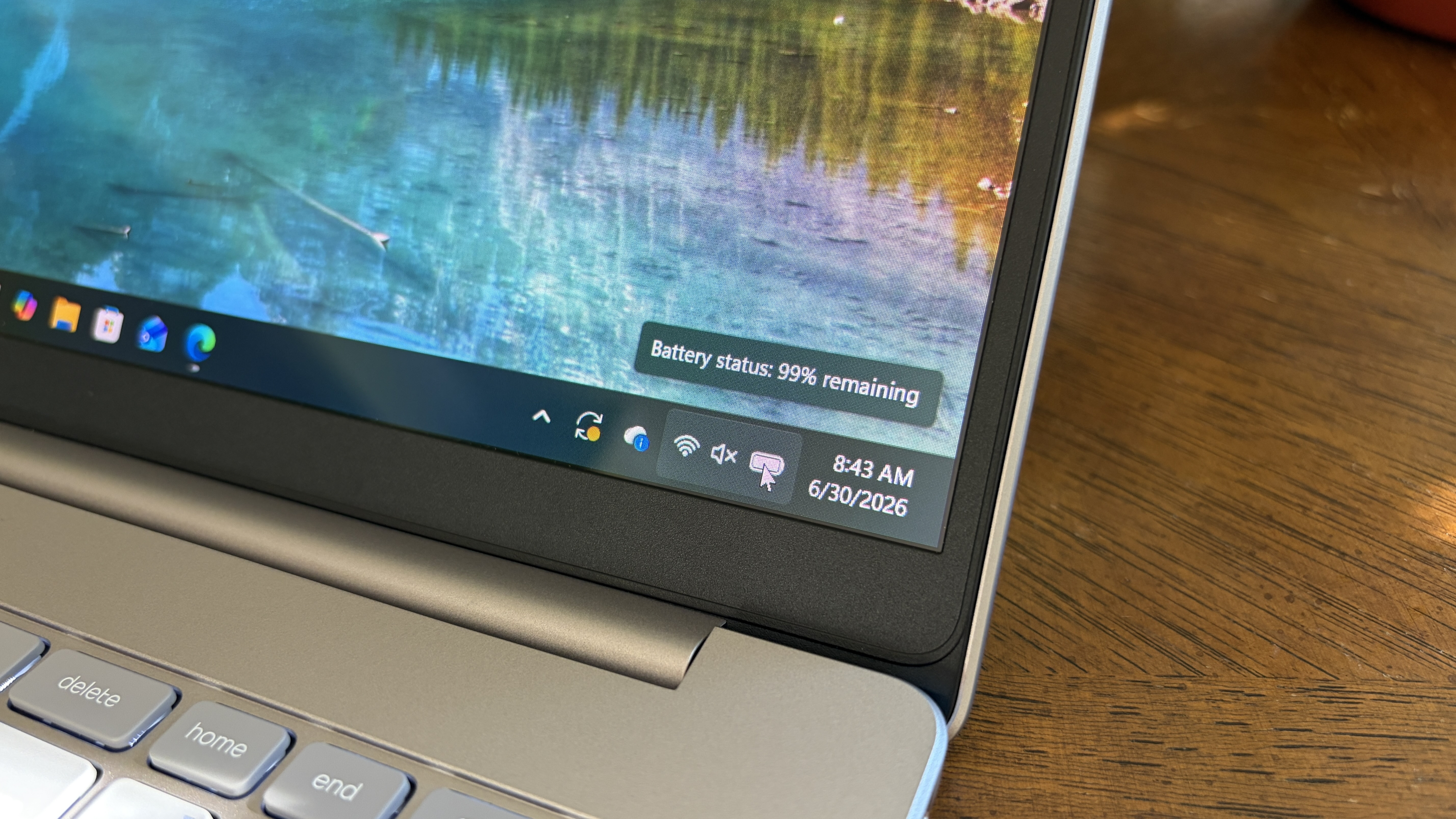 An OmniBook 3 laptop screen corner shows a battery status of 99% remaining and the time as 8:43 AM on June 30, 2026, against a colorful nature wallpaper.
