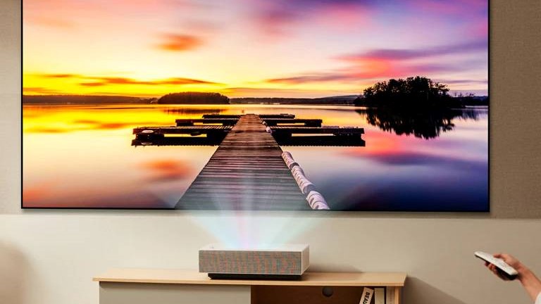 The LG Cinebeam HU715Q showing a beach view in a bright room