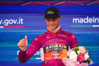 Bahrain Victoriouss Italian rider Jonathan Milan celebrates the best sprinters cyclamen jersey on the podium after the tenth stage of the Giro dItalia 2023 cycling race 196 km between Scandiano and Viareggio on May 16 2023 Photo by Luca Bettini AFP Photo by LUCA BETTINIAFP via Getty Images