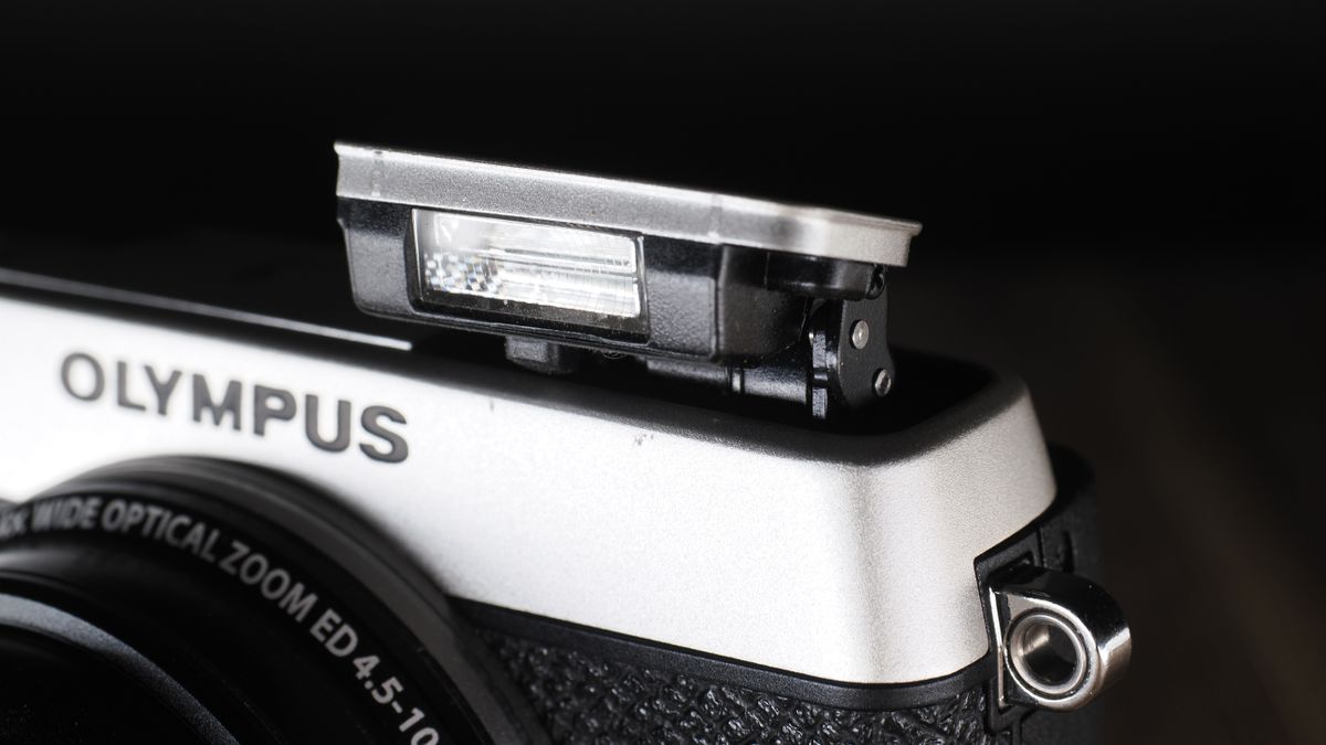 Olympus Stylus SH-3 on a wooden surface