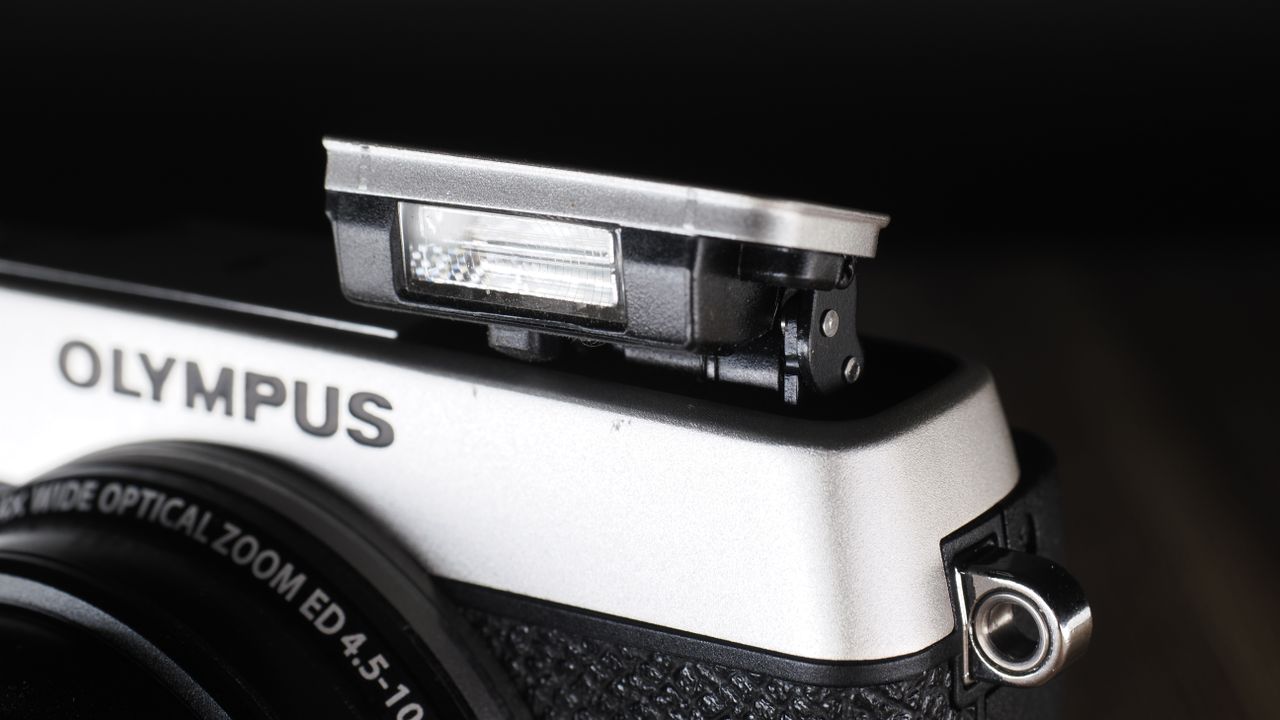 Olympus Stylus SH-3 on a wooden surface