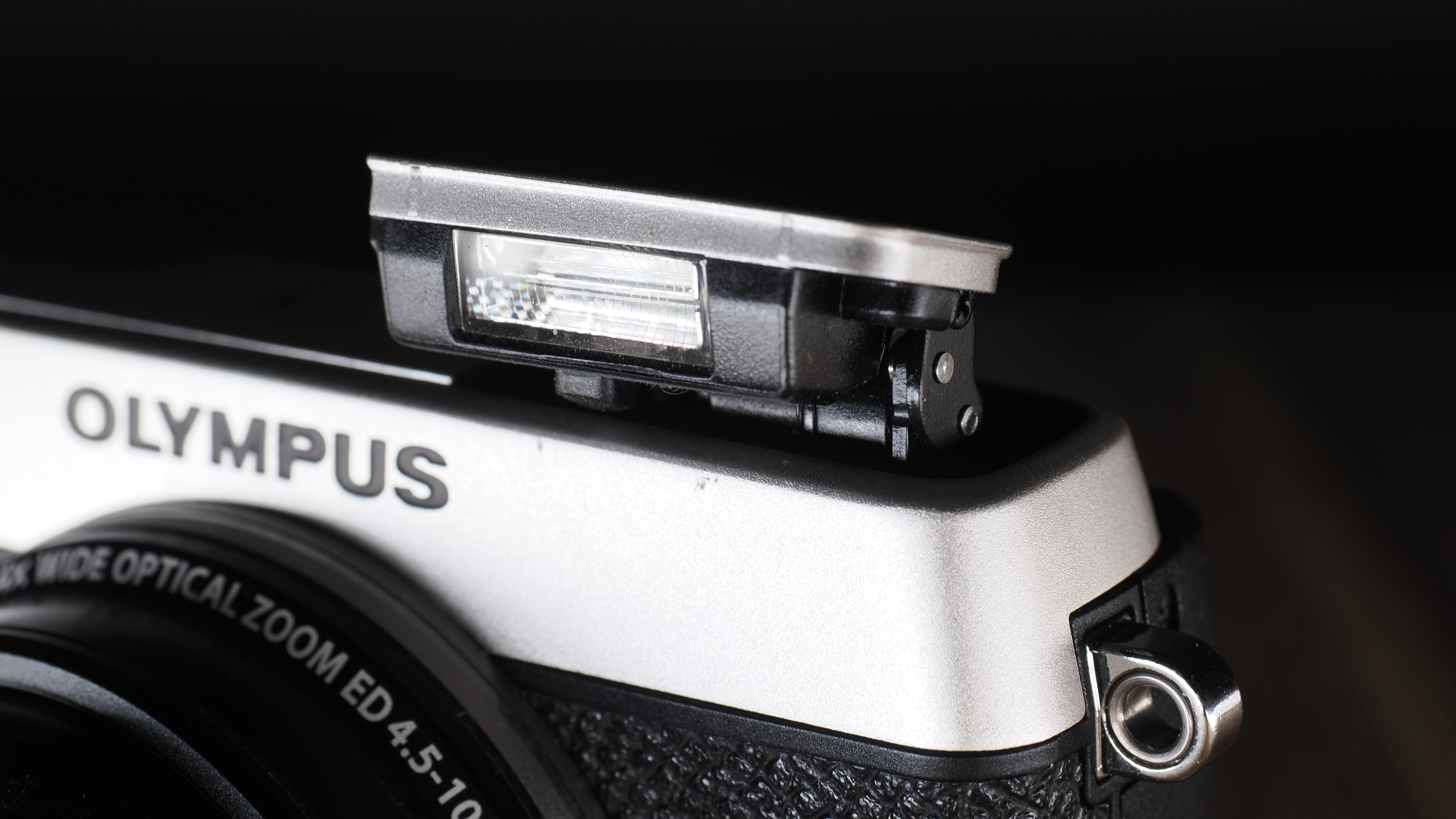 Olympus Stylus SH-3 on a wooden surface