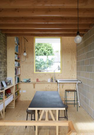 Studio and home office space with a desk and bookshelf at Forest House