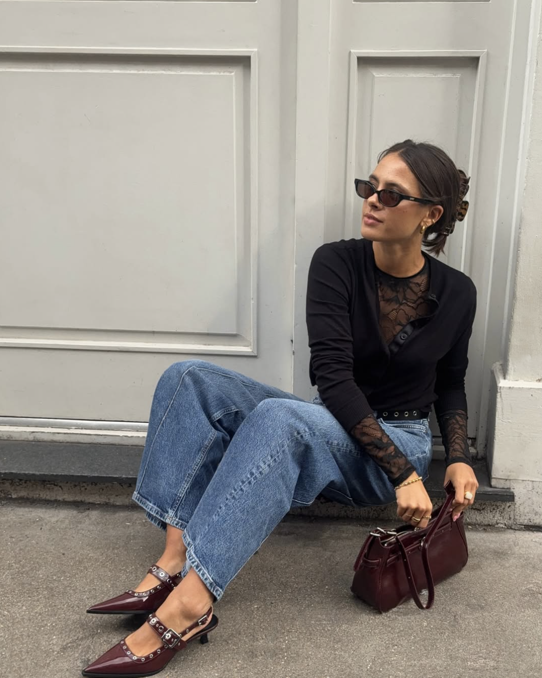 woman in jeans and a black lace top