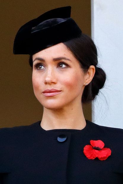 Meghan conceals tired eyes with highlighter. 