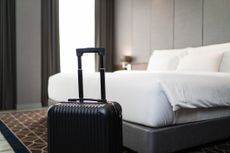 A suitcase placed in front of a luxury hotel room