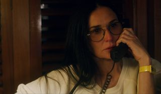 Songbird Demi Moore makes a phone call in the study
