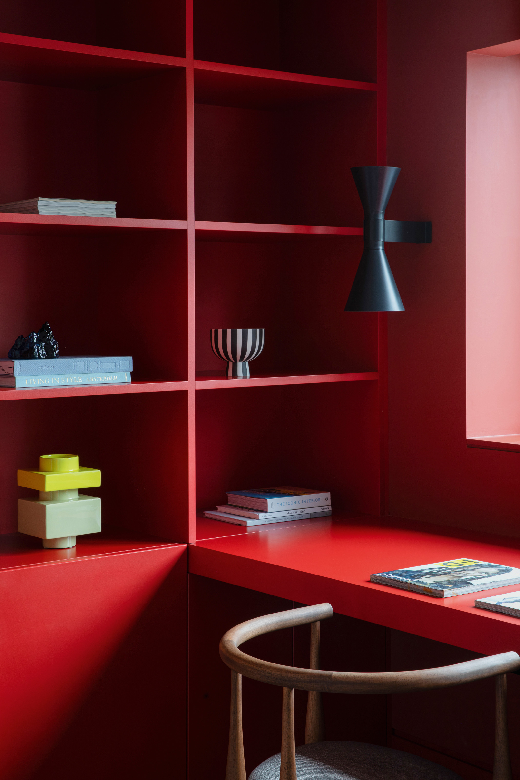 Home office with red lacquer desk and shelving
