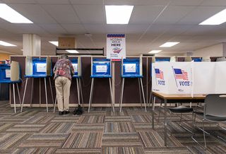 MINNEAPOLIS, MN - SEPTEMBER 23: A woman votes early at the Downtown Early Vote Center on September 23, 2016 in Minneapolis, Minnesota. Minnesota residents can vote in the general election every day until Election Day on November 8. (Photo by Stephen Maturen/Getty Images)