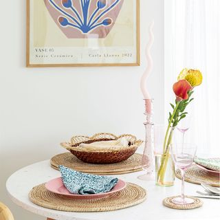 dining area with round table and pink dinnerware