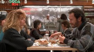 Meg Ryan and Billy Crystal sitting at a table at Katz's Deli