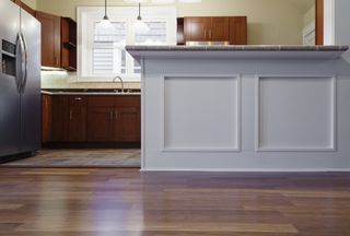 A kitchen floor and cabinets viewed from ground level