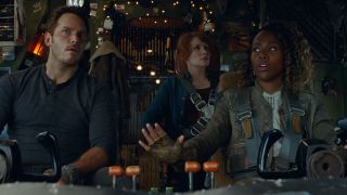 Chris Pratt, Bryce Dallas Howard, and DeWanda Wise look up from the cockpit with concern in Jurassic World Dominion.