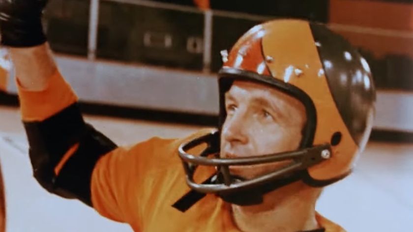 James Caan wearing a helmet with his arm raised in Rollerball