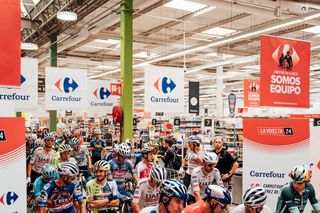 The peloton awaits Vuelta a España stage six from within a supermarket