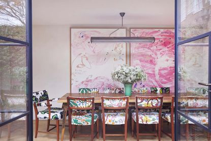 A dining room with larger than life artworks