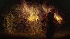 A man is showered in embers during a fire performance as part of the autumn equinox celebrations in Vilnius, Lithuania