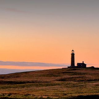 sea side lighthouse with sunset