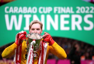 Liverpool goalkeeper Caoimhin Kelleher holds up the Carabao Cup