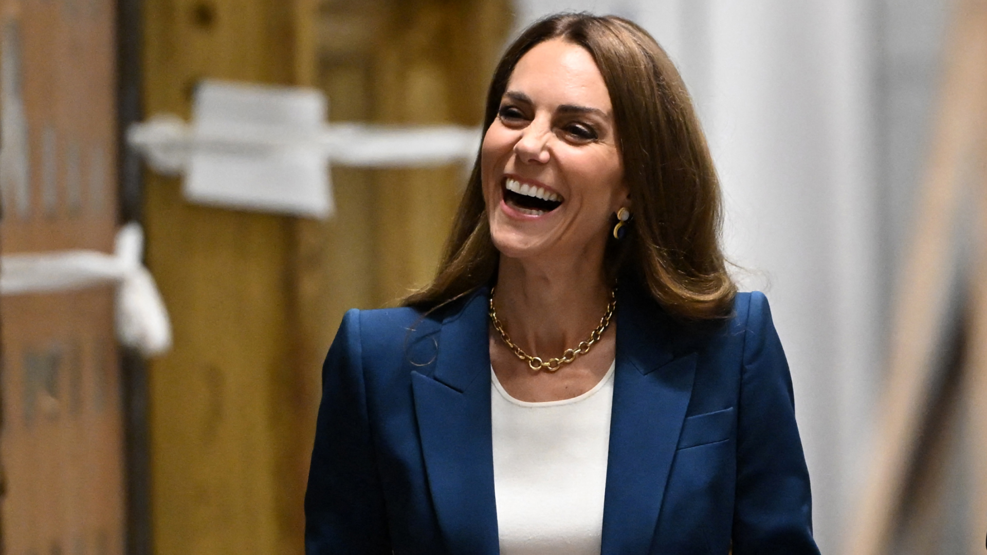 Princess Kate wearing a blue suit and laughing