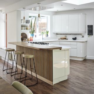 white kitchen with wood worktop and flooring