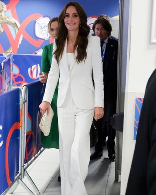 Kate Middleton wearing a white trouser suit