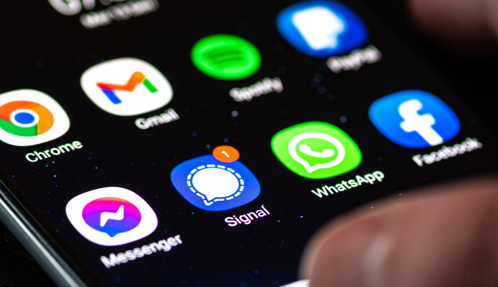 The Facebook Messenger, Signal, WhatsApp and Facebook app icons on the screen of an Android phone.