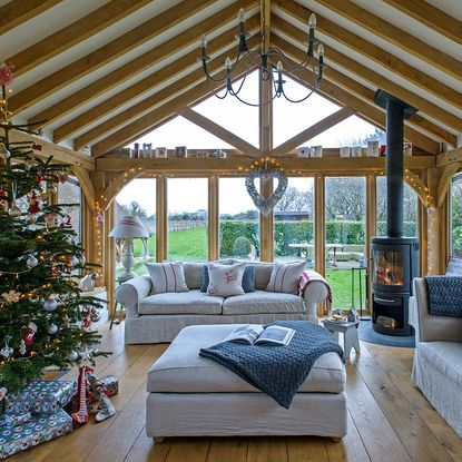 garden room with wooden flooring and grey sofa