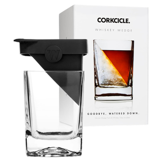 A whiskey glass with an angled ice wedge topper mold and its packaging