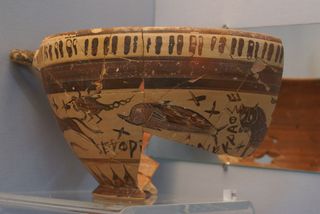 A Greek wine cup showing a large dog, scorpion, dolphin and a panther/lion, possibly symbolizing constellations.