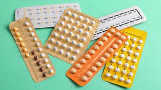 Birth Control Pills on a green background