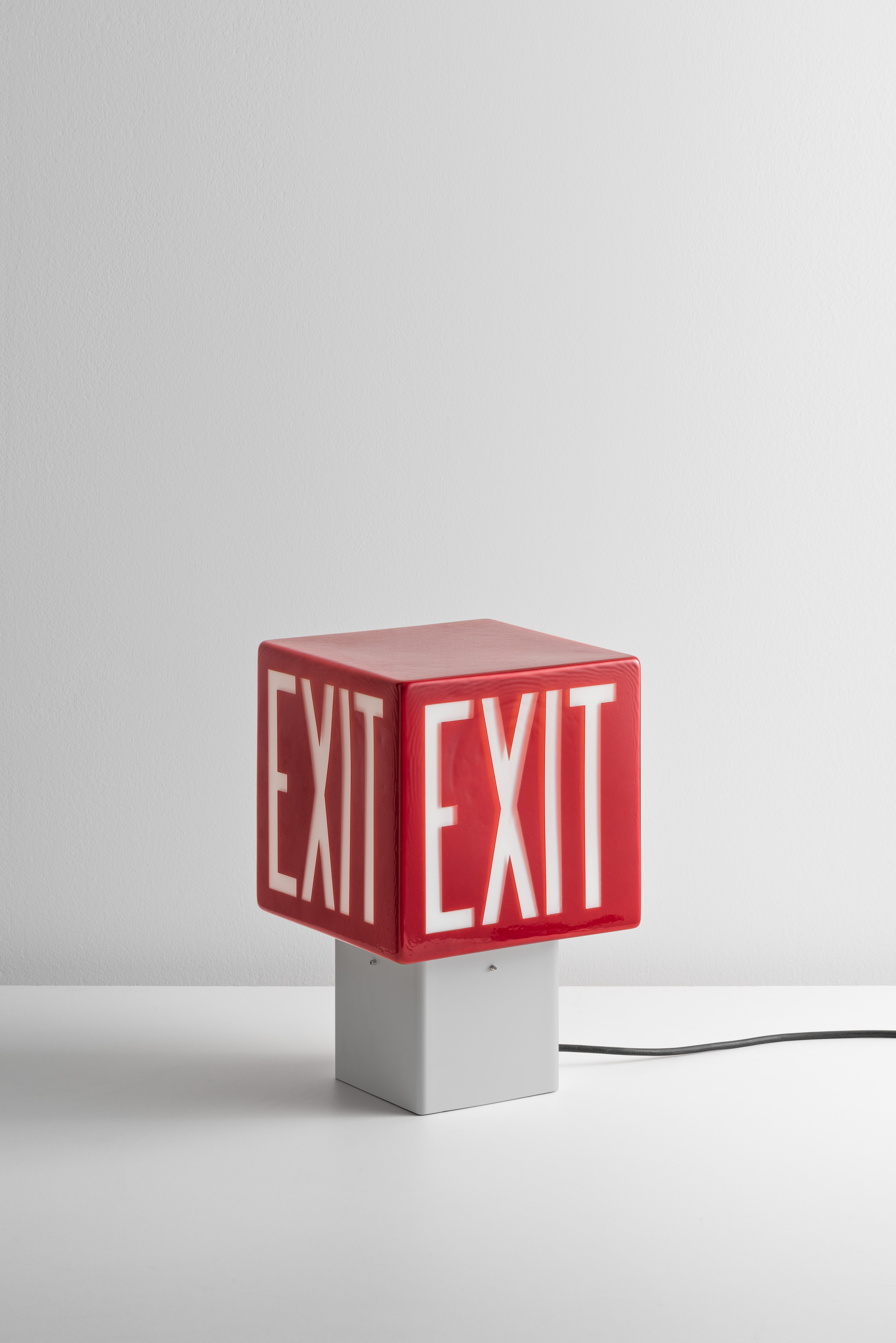 red glass lamp with &#039;EXIT&#039; written on its surface