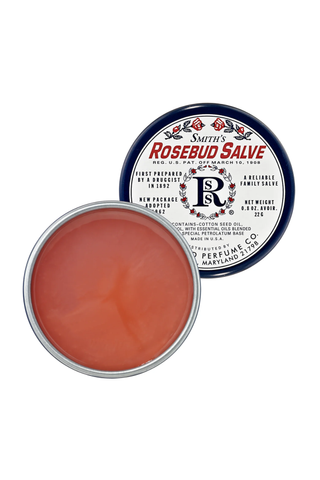 An opened but untouched tin of Smith's Rosebud Salve set against a white background.