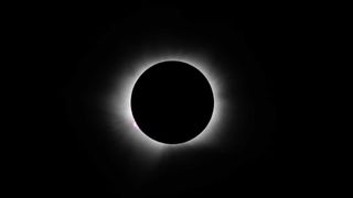 a thin white line of wispy light on a black background