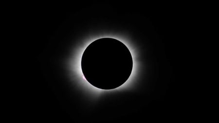 a thin white line of wispy light on a black background