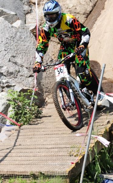 Bryn Atkinson over a wooden bridge.