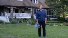 Steve Carrell stands outside a property on the front lawn in The Four Seasons TV show on Netflix