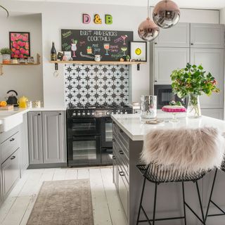 grey kitchen with pink pendant lights and floor runner